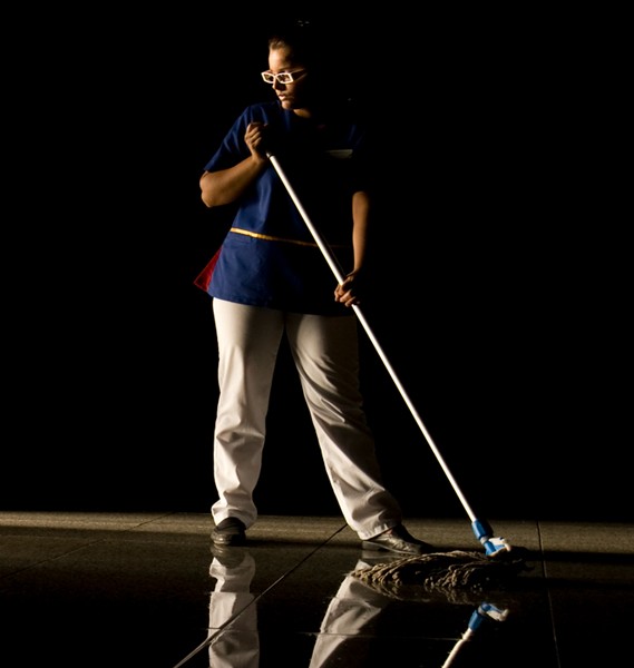 Woman mopping in the dark